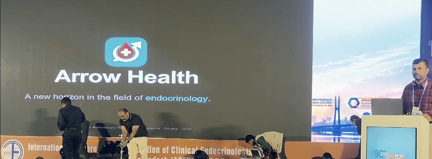 A conference hall with Arrow Health and the words 'A new horizon in the field of endocrinology' on the main screen; Dr. K. M. Nahid Ul Haque stands at the lectern on the right.