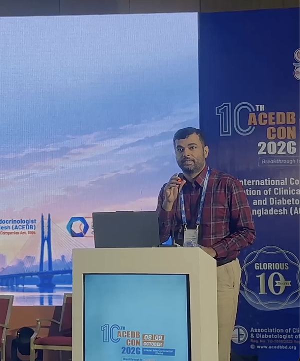 Dr. K. M. Nahid Ul Haque speaking at the lectern, with the 10th ACEDB CON 2026 banner behind him.
